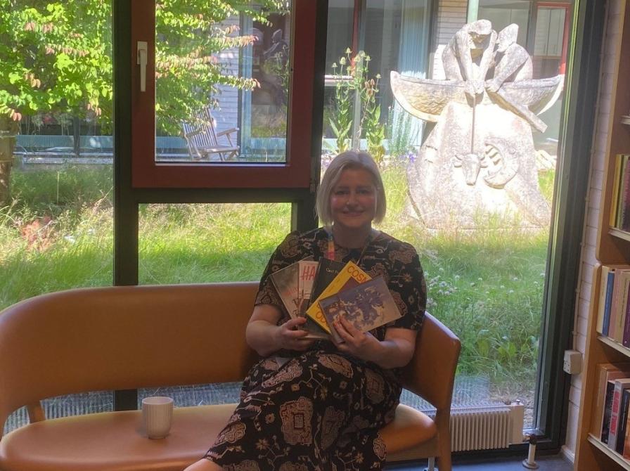 Bibliotekar Annebeth Møller sidder i sofa på Espergærde Bibliotek 